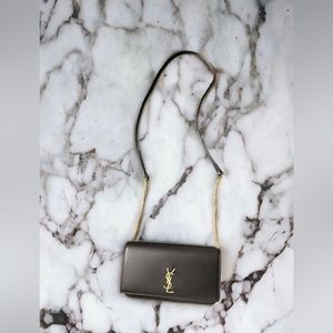 Leather black crossbody wallet included with YSL envelope cover.